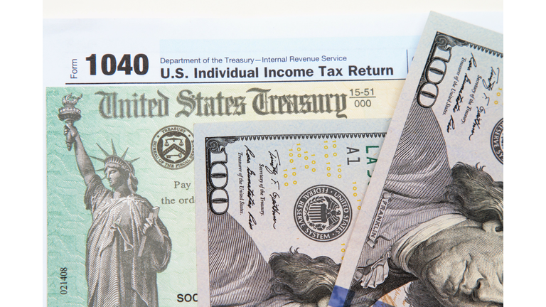 IRS tax form with tax refund check and USA currency