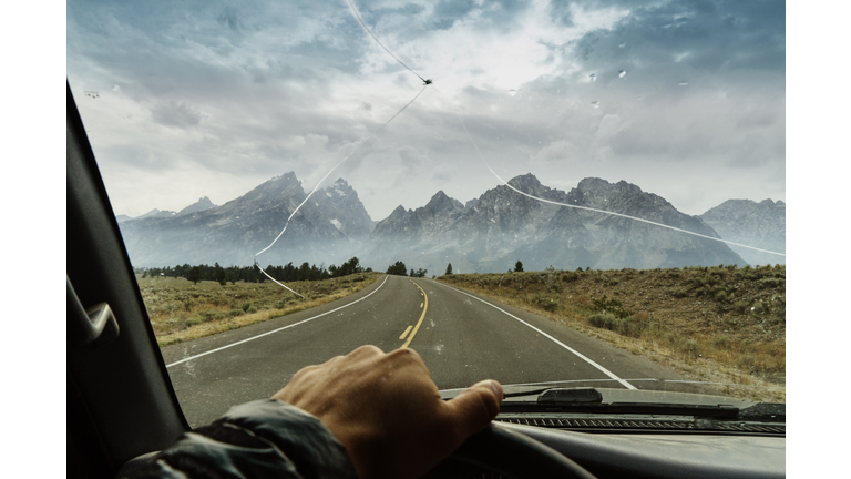 Cropped hand of man driving truck