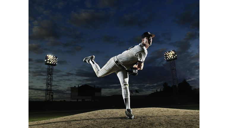 Baseball player pitching off mound