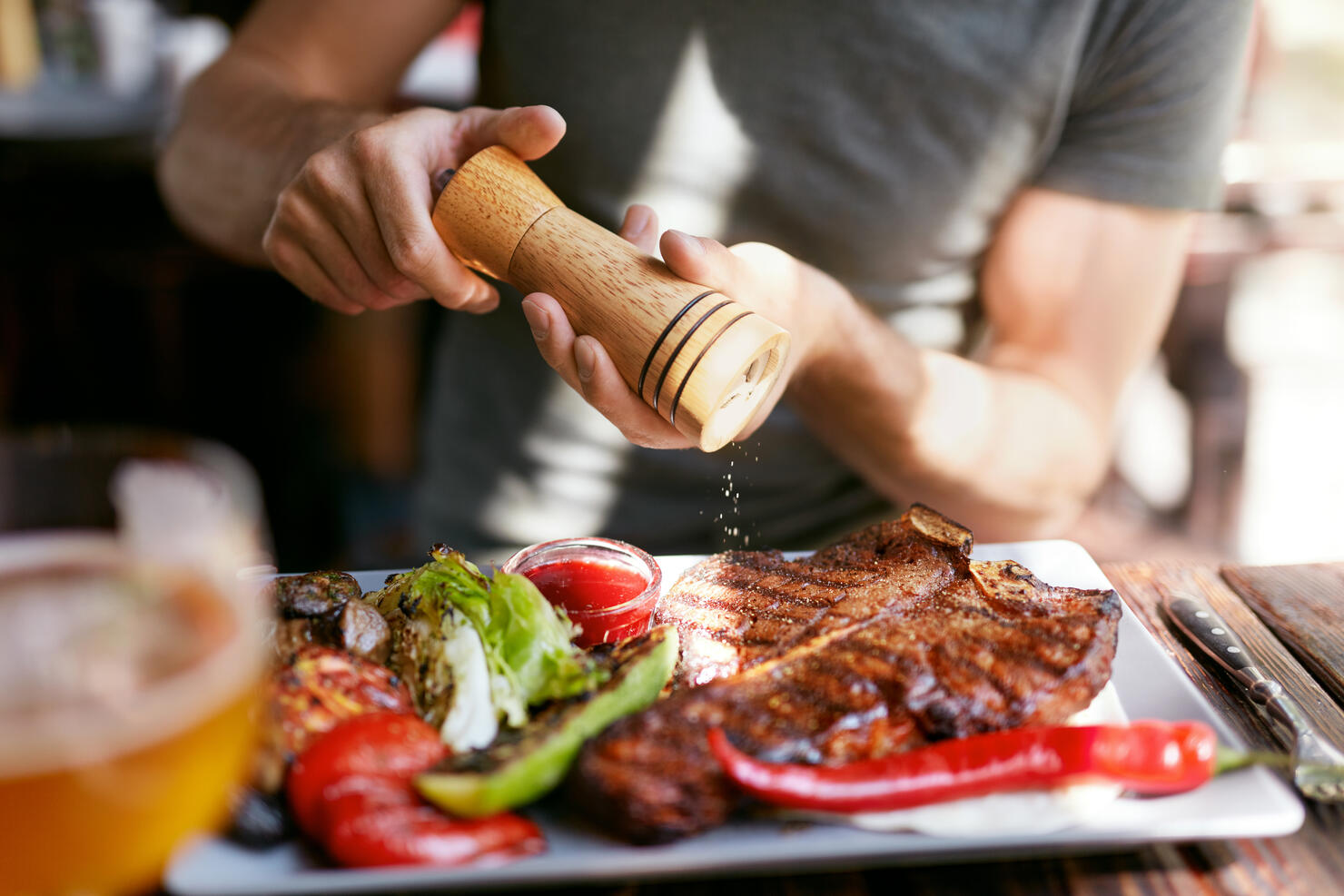 Man Eating Grill Meat With Vegetables Closeup.