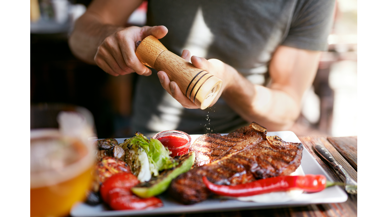 Man Eating Grill Meat With Vegetables Closeup.