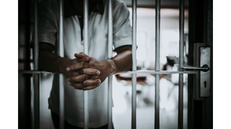 Midsection Of Man Standing In Prison