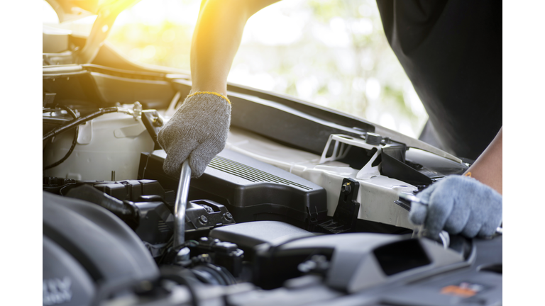 Professional mechanic checking car engine.