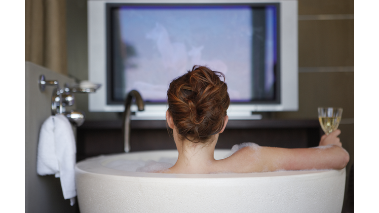 Young woman in bath, rear view