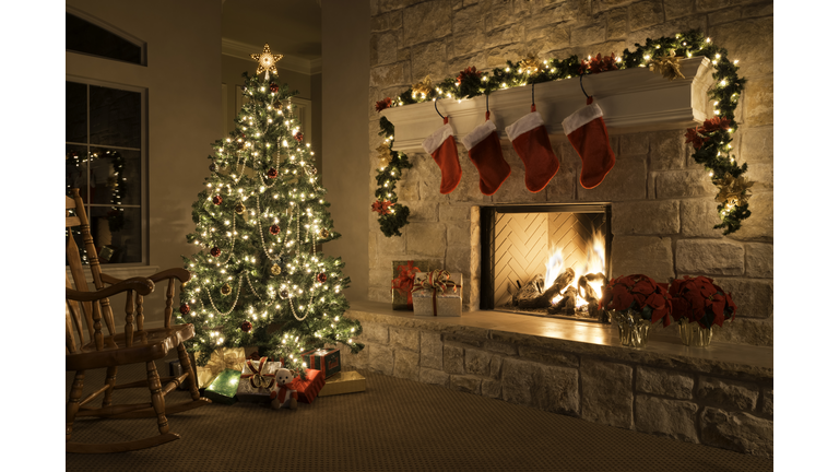 Christmas stockings, fireplace, tree, and decorations