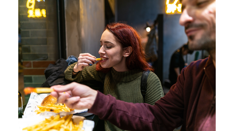 Hungry couple in fast food restaurant