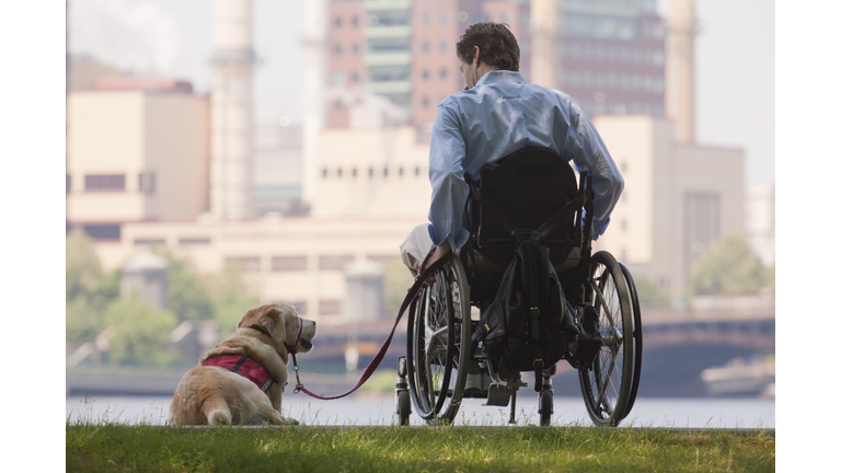 Disabled man with his service dog in a park