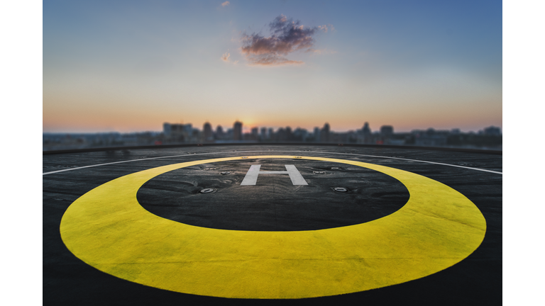 Helipad on the roof of a skyscraper with cityscape view