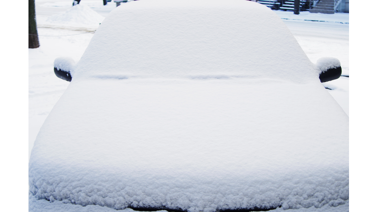 Frozen car covered snow at winter