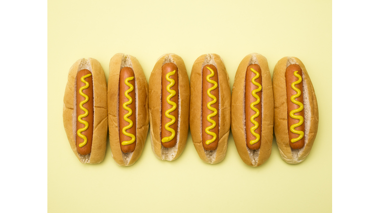 Hot dogs against a plain background