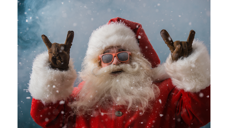 Santa Claus wearing sunglasses dancing outdoors at North Pole