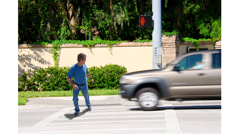 Jaywalking man about to be run over by truck