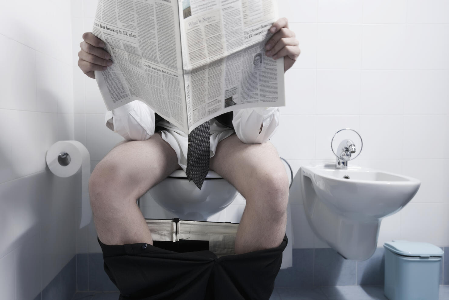 Man defecating in toilet
