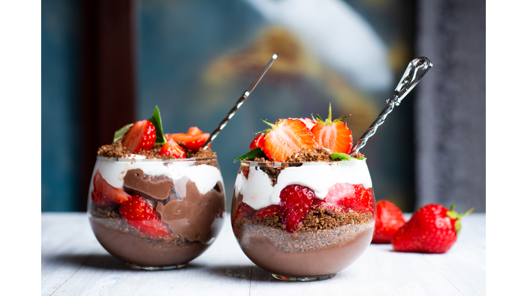 Strawberry parfait dessert in a glass cup with cream and chocola