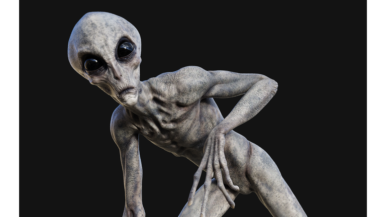 a gray alien on dark background with clipping path.