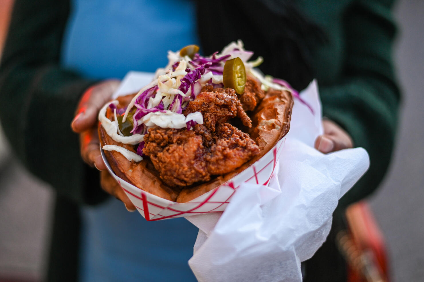 Close-Up Of Hand Holding A Fried Chicken Sandwich