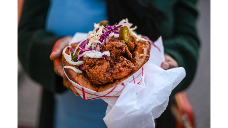 Close-Up Of Hand Holding A Fried Chicken Sandwich