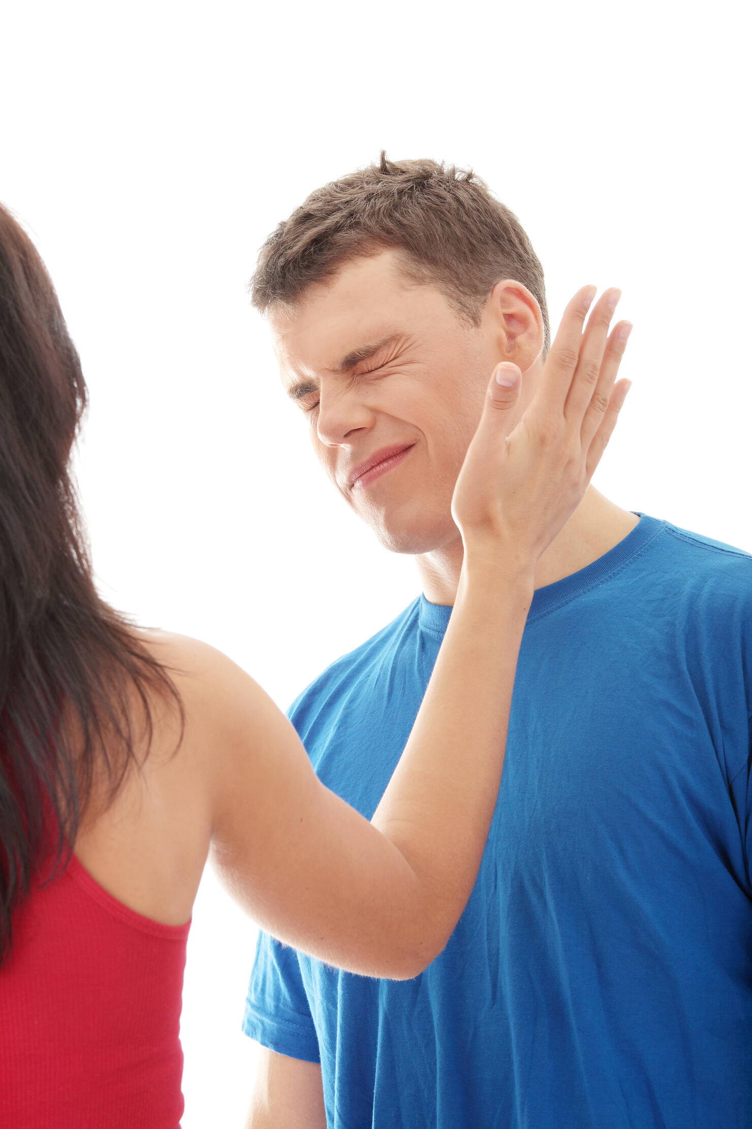 Close-Up Of Woman Slapping Man Against White Background