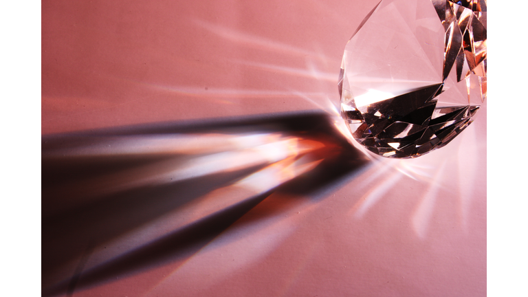 Close-Up Of Diamond With Shadow Pattern On Pink Table