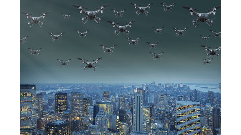 flock of drones over a city