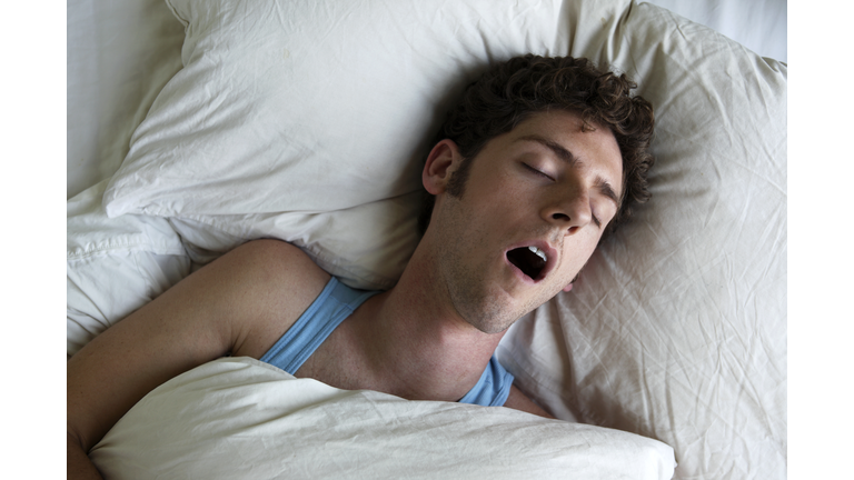 Man sleeping and snoring, overhead view