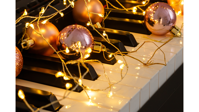 A piano with christmas lights and tree