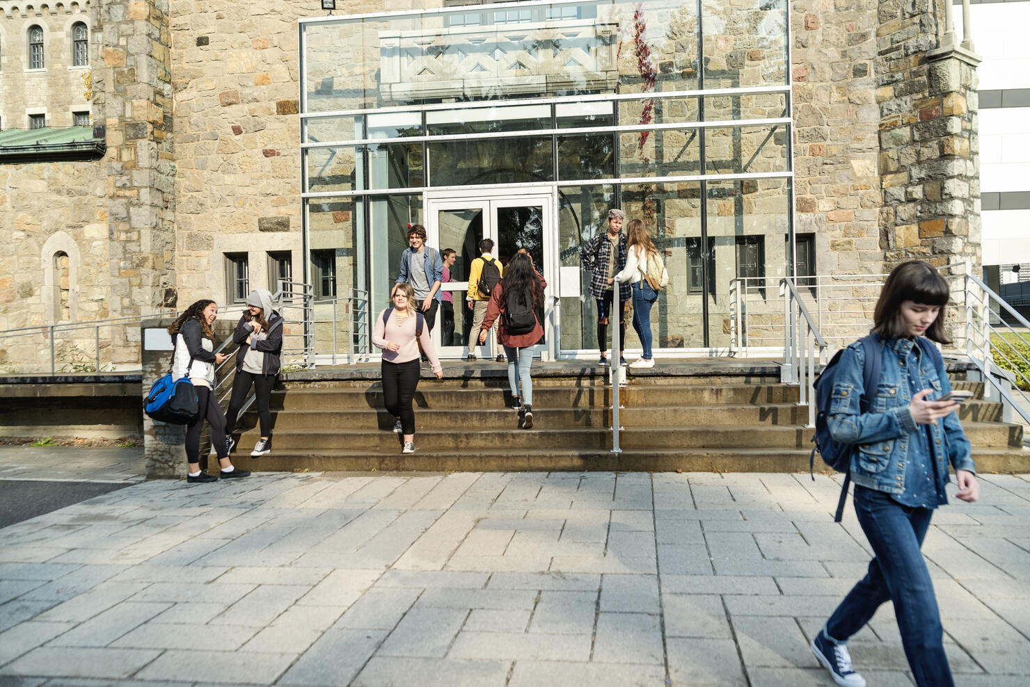 Multi-ethnic group of students in front of College University entrance.