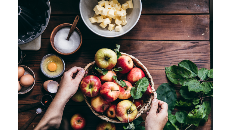 Woman baking cake with freshly picked apples