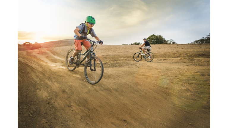 Boy riding dirt bikes on track