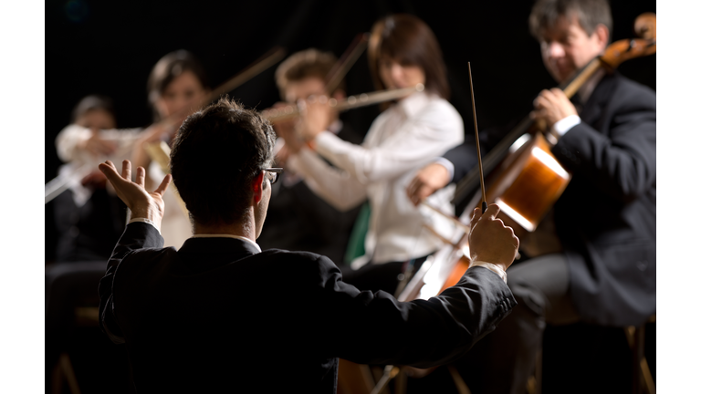 Conductor directing symphony orchestra