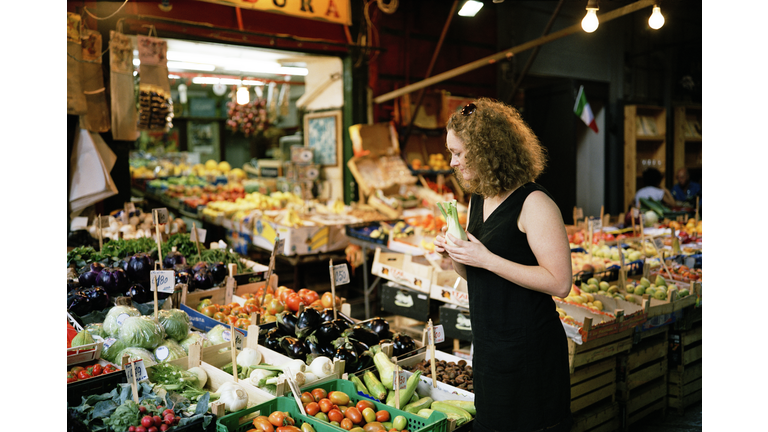 Woman looking at fresh produce stall in Palermo