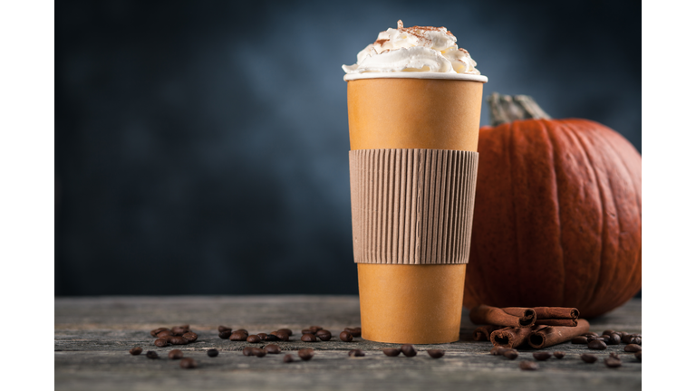 Pumpkin spice latte in a paper cup