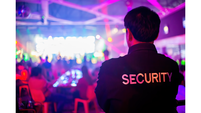 Security guard  are regulating the situation of safety in an event concert in a nightclub.