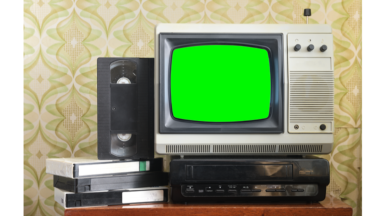 Old silver vintage TV with green screen to add new images to the screen, VCR on wallpaper background.