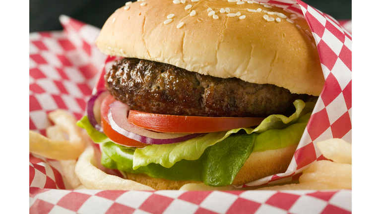 Hamburger with lettuce, tomato, red onion and French fries