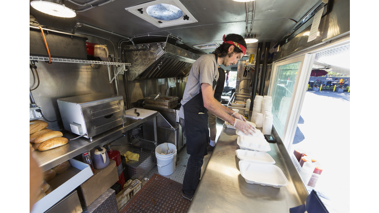 Caucasian chef working in food truck kitchen