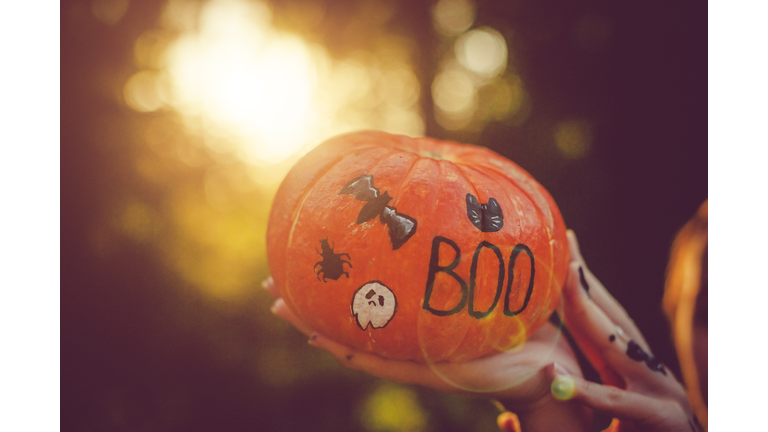 Women holding Halloween pumpkin