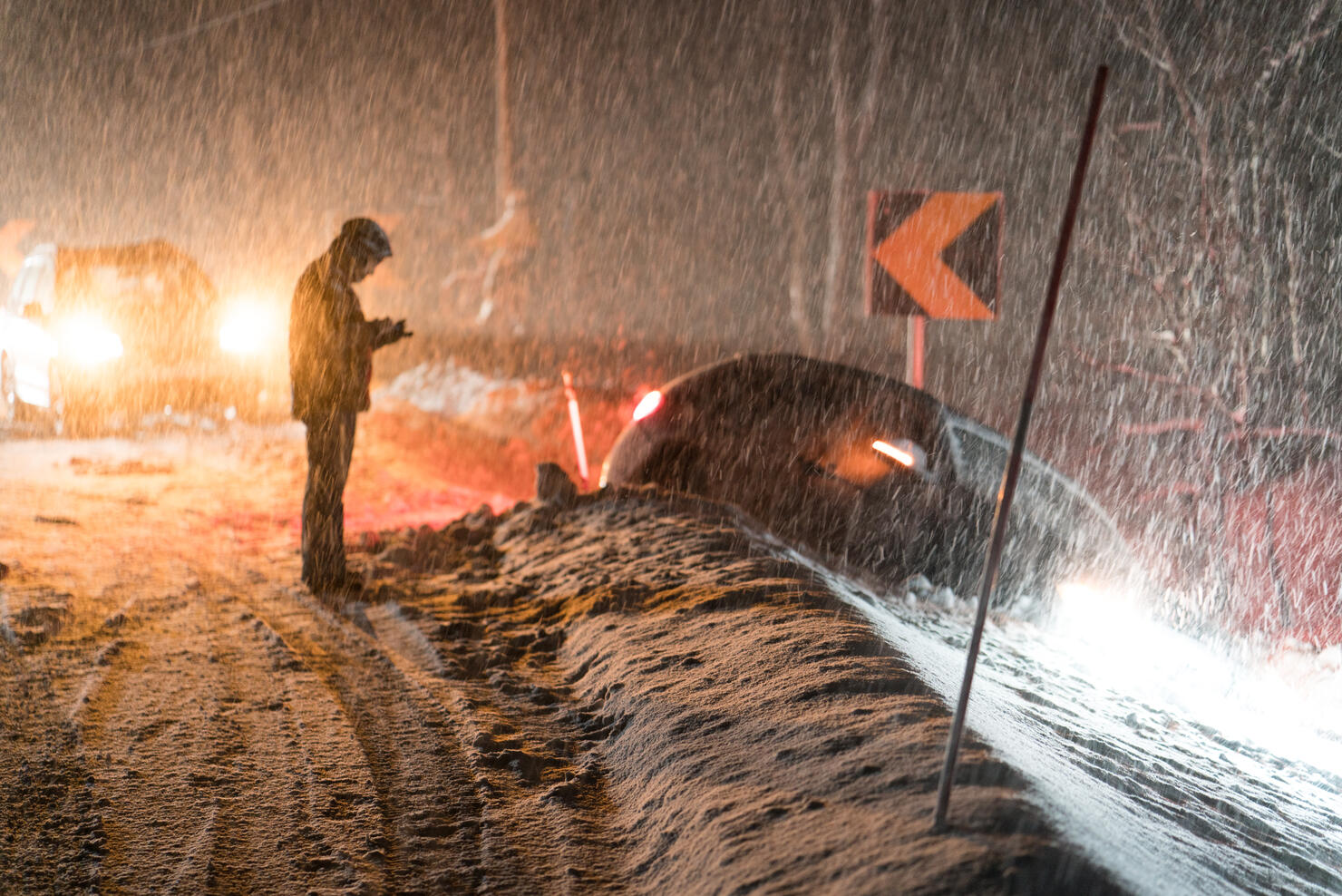 Man calling for help for car accident in snow