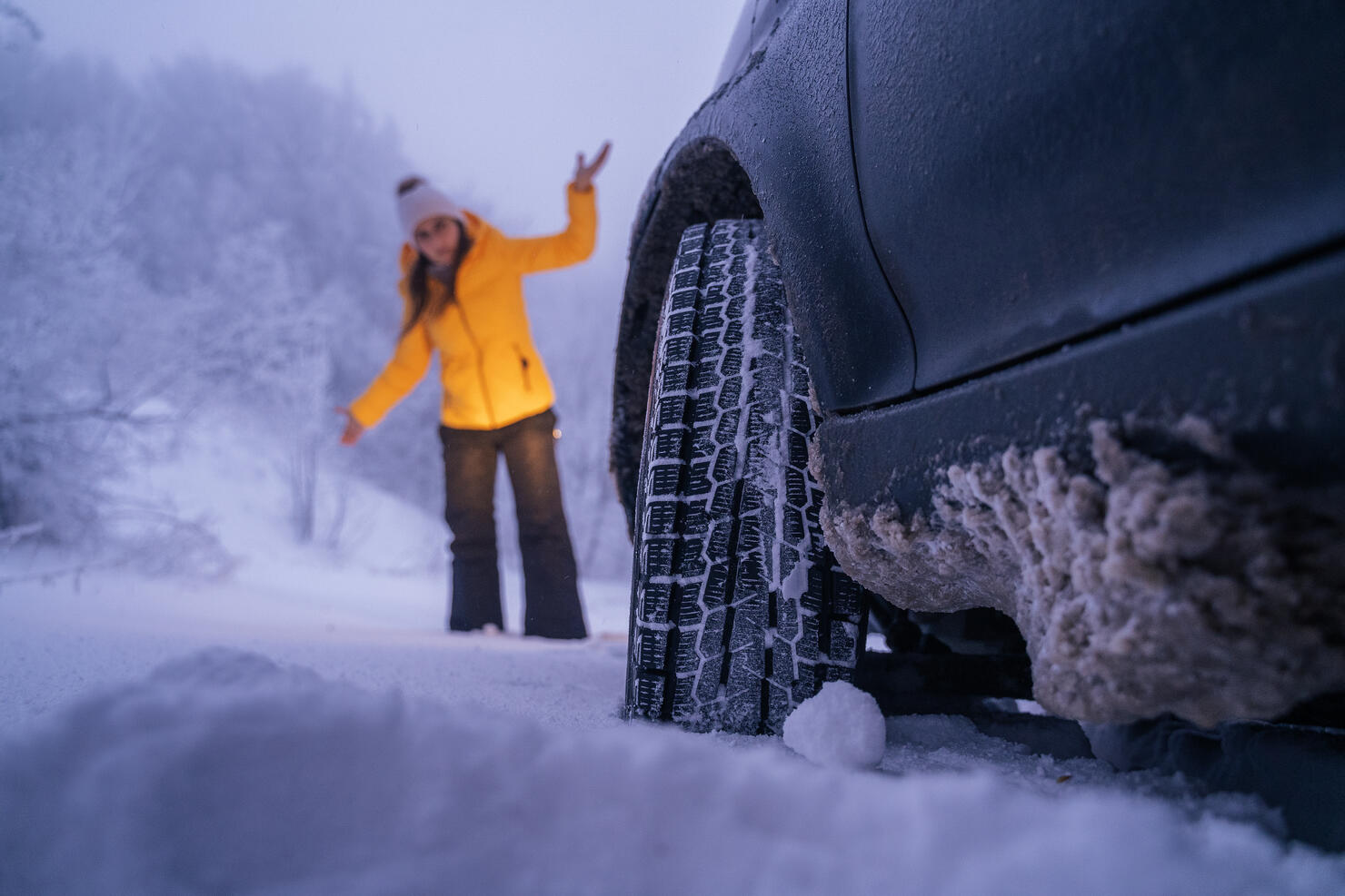 Driving in Snow. Car break on the road. Car issues in the middle of nowhere in bad weather. Car insurance. One woman on the road.