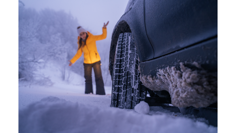 Driving in Snow. Car break on the road. Car issues in the middle of nowhere in bad weather. Car insurance. One woman on the road.