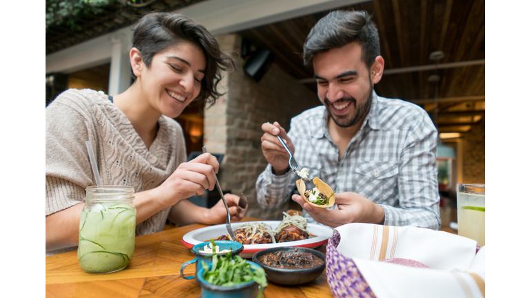 Happy couple eating at a restaurant