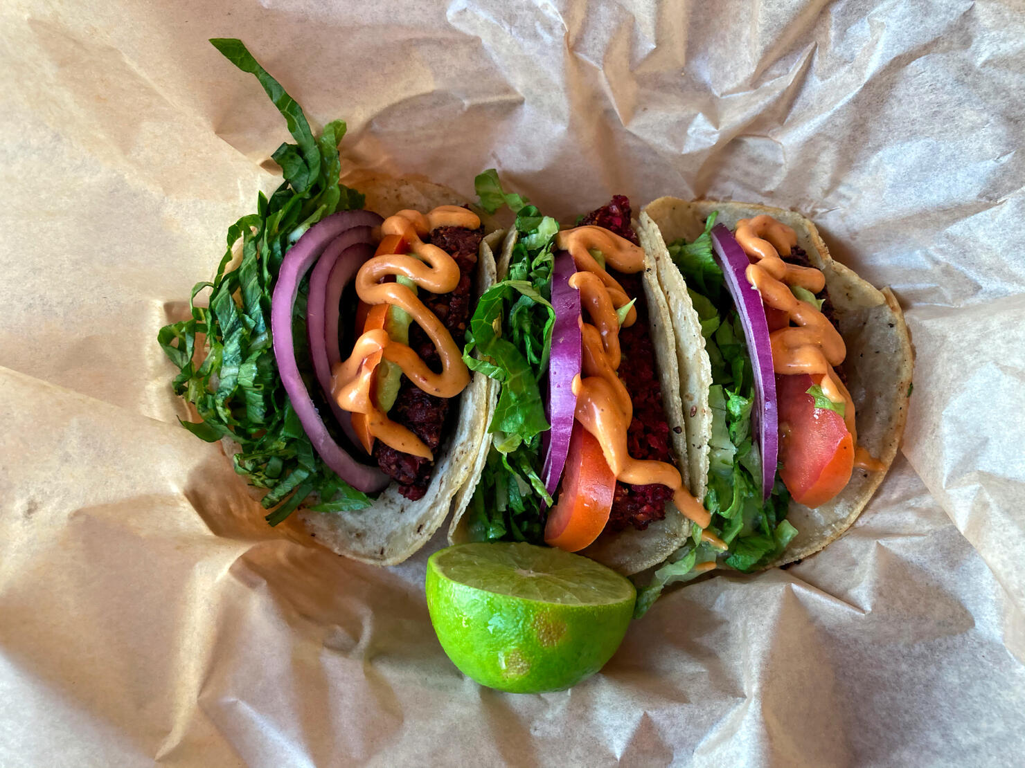 Vegetarian tacos served with chilli mayonnaise and fresh lime