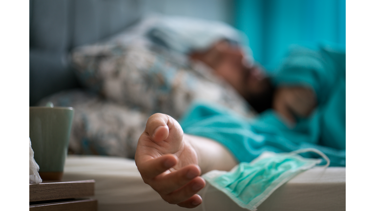 Hand of sick man in bed