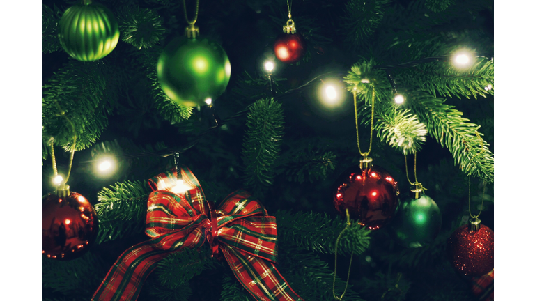 Close-Up Of Decoration On Illuminated Christmas Tree At Night