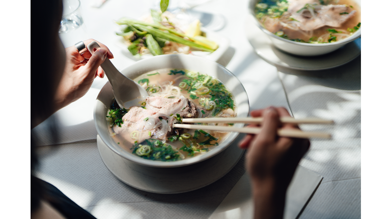 Woman Eating Vietnamese Pho Soup With Noodles And Beef