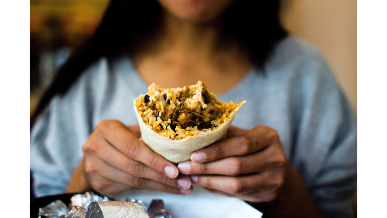 Midsection Of Woman Holding Burrito