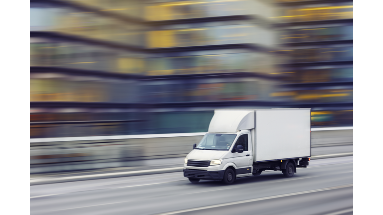 Fast delivery truck travelling through the city streets