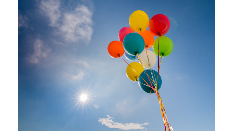 Multicoloured balloons against blue sky