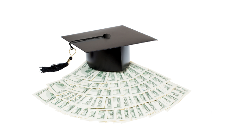 Paid education. Graduate cap on bank notes