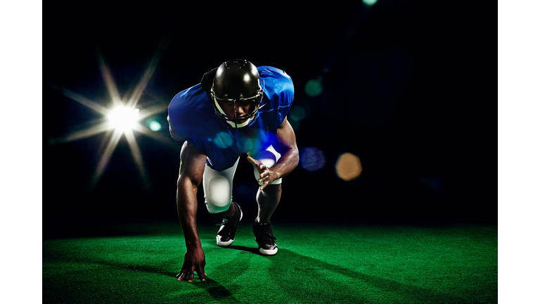 American football player crouching